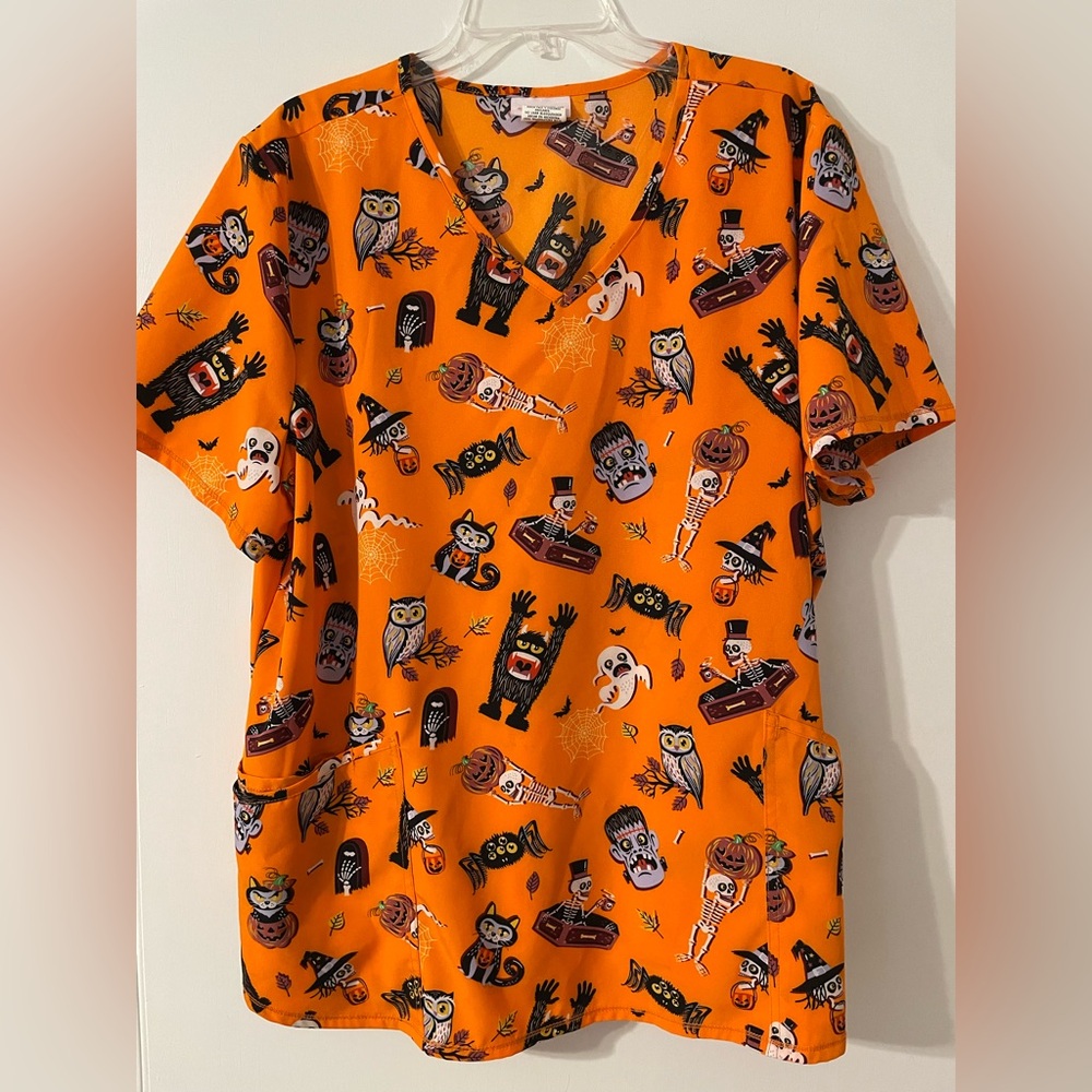 Holiday Halloween Scrub Top feat. skeletons, black cats, pumpkins, Frankenstein